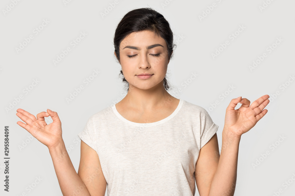 Peaceful indian girl posing meditate with mudra hands
