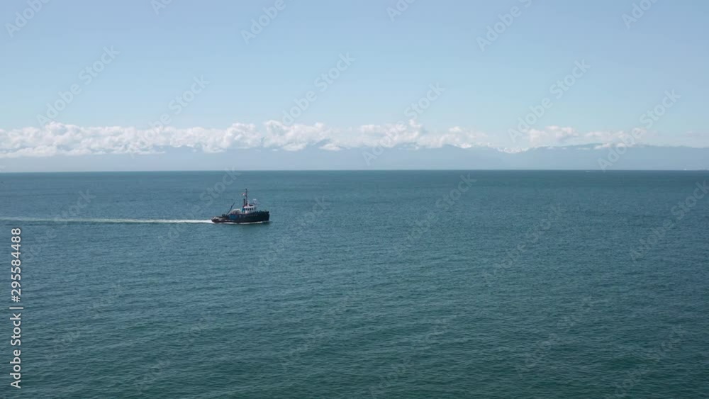 Shipping vessel moving across sea in tranquil calm ocean water, aerial view Shipping vessel moving across sea in tranquil calm ocean water, aerial view
