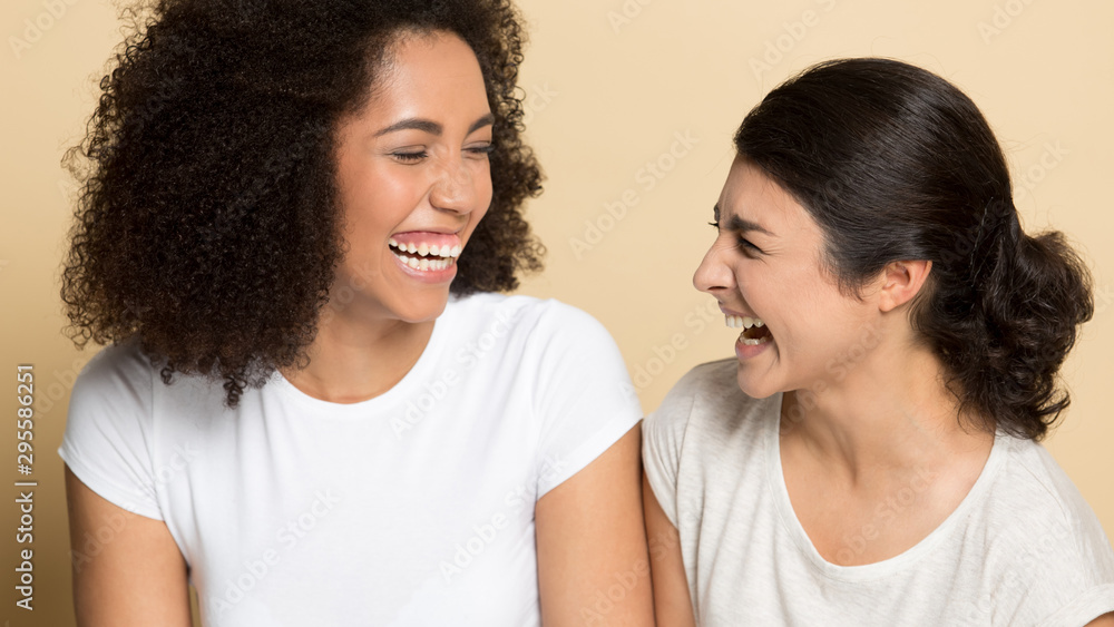 Overjoyed multiethnic friends have fun laughing together Overjoyed multiethnic friends have fun laughing together
