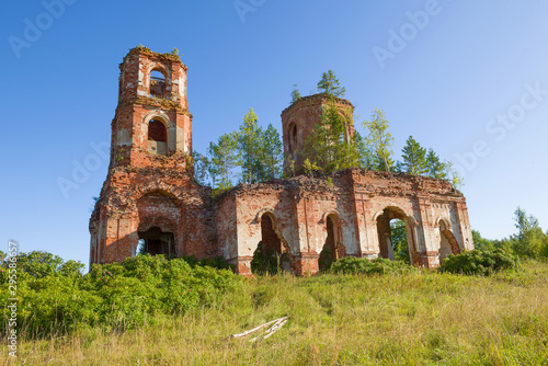 Abandoned old church of the Icon of the Mother of God of Kazan on a sunny August day. Ruskie Noviki. Novgorod region, Russia photo