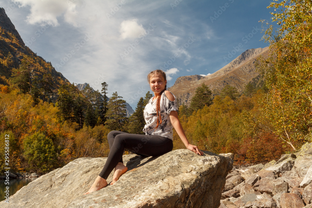 Girl traveler in the autumn forest in the mountains Girl traveler in the autumn forest in the mountains