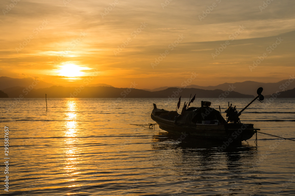 Long tail boat at sunset