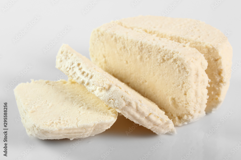 Capreggio Goat Cheese. Isolated on gray background. Capreggio Goat Cheese. Isolated on gray background.