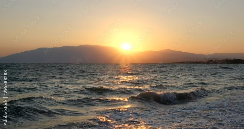 Amazing sunrise over the tropical beach. Yellow sun over sea. Orange colors waves. Nature background. Beautiful serene scene. Morning. Sunlight reflect on water surface Amazing sunrise over the tropical beach. Yellow sun over sea. Orange colors waves. Nature background. Beautiful serene scene. Morning. Sunlight reflect on water surface