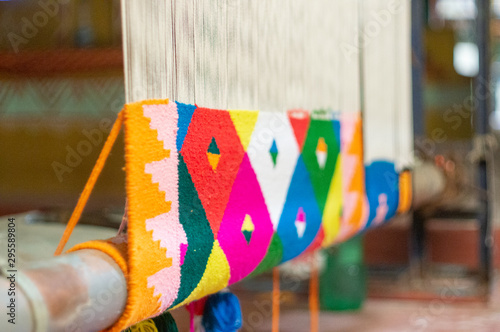 Traditional indian dari or carpet being woven on a manual loom photo