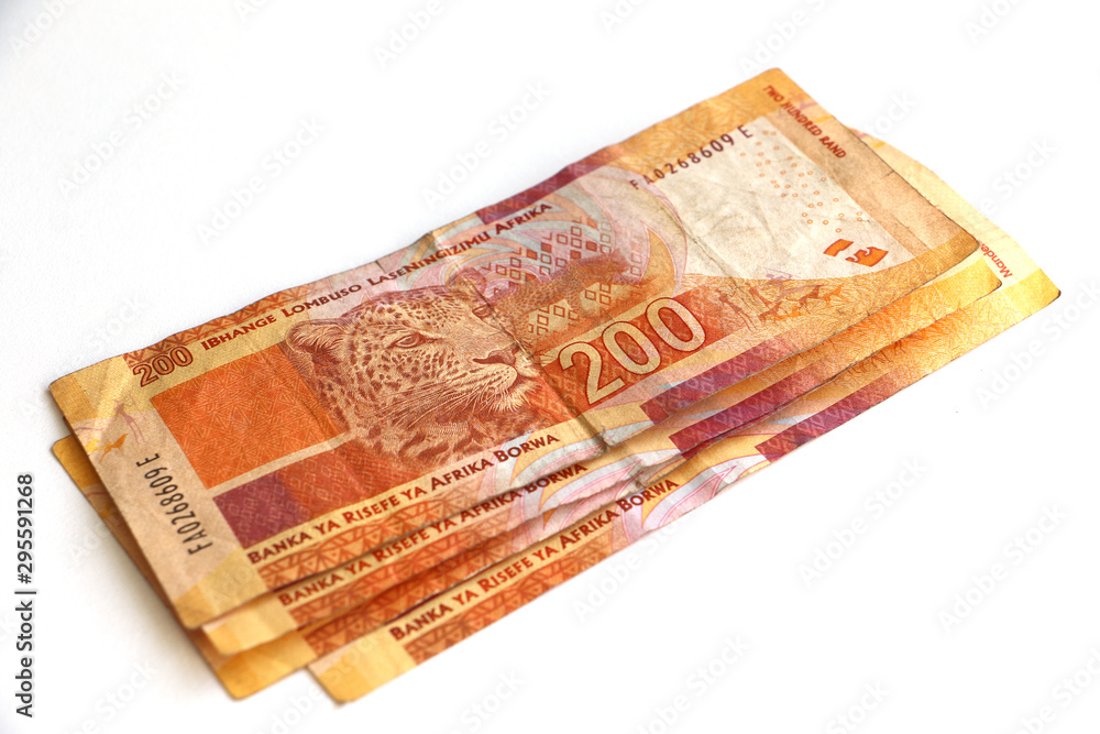 South African money, stacked, piled currency, two hundred rand notes South African money, stacked, piled currency, two hundred rand notes