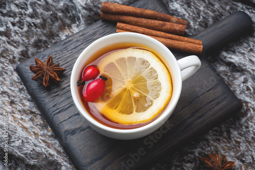 Drink from wild rose berries with lemon and honey cinnamon. Vitamin useful decoction of rose hips. cozy home concept of winter drink