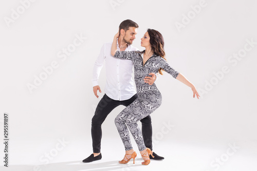 Passionate couple dancing social danse kizomba or bachata or semba or taraxia on white background with copy space