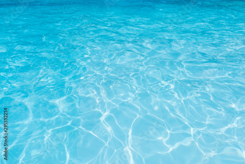 Blue water surface in swimming pool with sun reflection   Ripple wave in pool for background and abstract