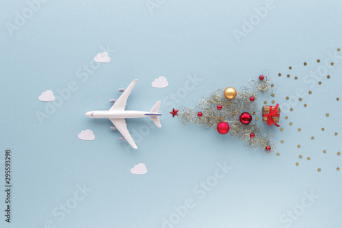 Christmas composition. Airplane flying in sky star gift bauble top view background with copy space for your text. Flat lay