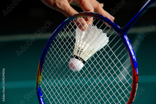 Young woman badminton player ready to serve shuttlecock during the game. © Jack Tamrong