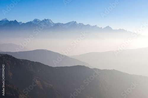Misty landscape in himalayas. Foggy mountain shapes. Beautiful view on everest base camp track.