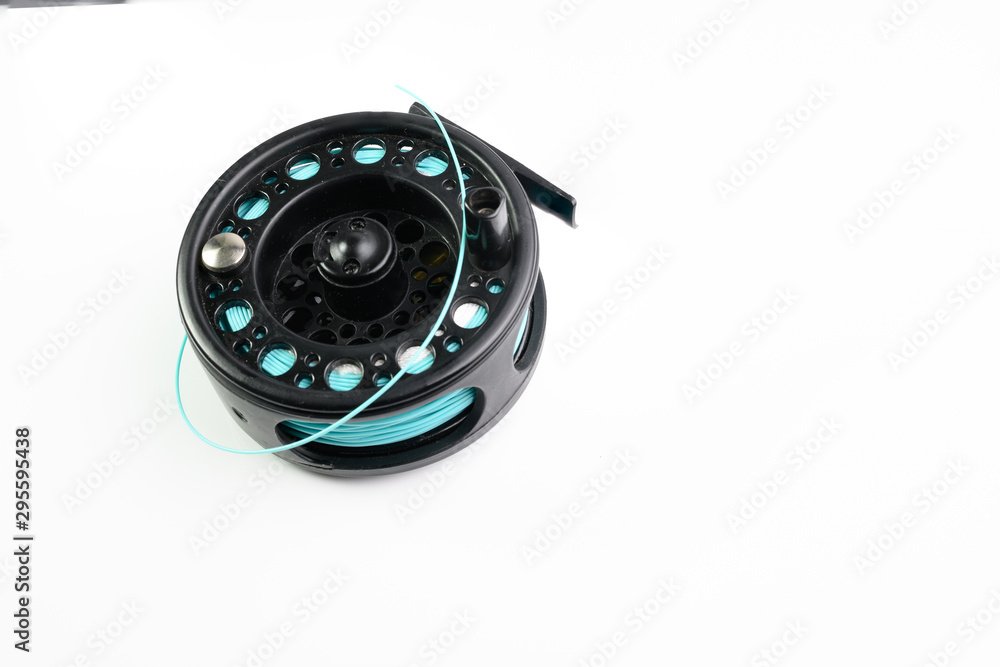 black fly fishing Reel and line isolated on a white background with copy space black fly fishing Reel and line isolated on a white background with copy space