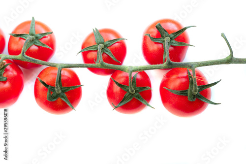 Sprig of chery tomatoes on a white background photo