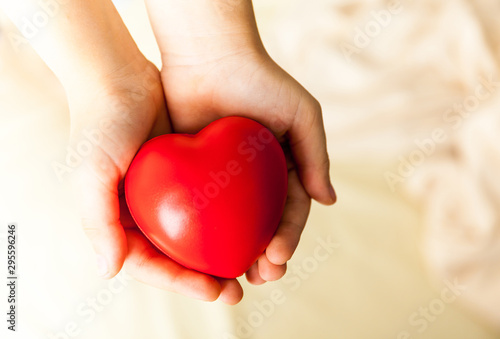 child hands holding red heart  health care  donate and family insurance concept