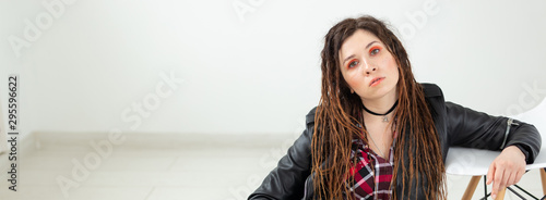 Dreadlocks, hairdresser and style concept - A stylish girl with dreadlocks and in leather jacket and fashionable makeup, copyspace photo