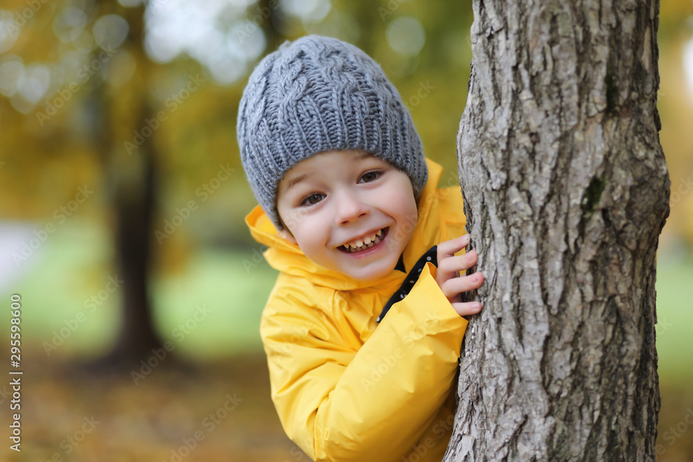 A child in a raincoat for a walk outside