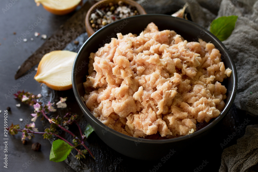 Minced meat and ingredients for cooking minced meat in a bowl on a slate. Minced meat and ingredients for cooking minced meat in a bowl on a slate.