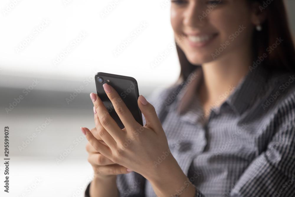 Close up happy young woman holding smartphone. Close up happy young woman holding smartphone.
