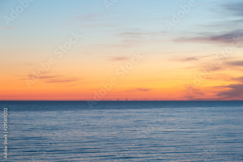 Beautiful Summer landscape sunset image of colorful vibrant sky over calm long exposure sea © veneratio