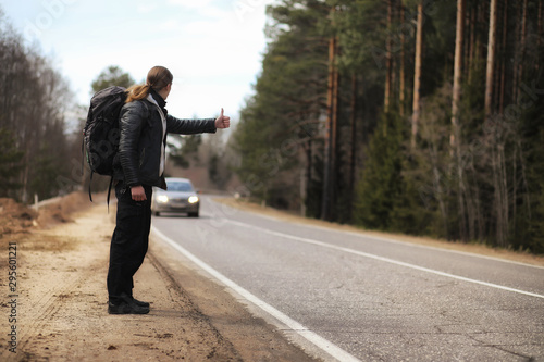 Fotografija A young man is hitchhiking around the country
