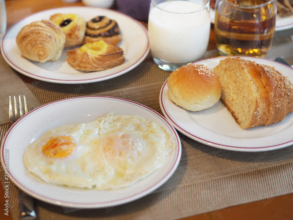 breakfast with french toast and jam Minibun bread ,mini Croissant with sweet crispy pie and bakery meal serve with egg fried , milk and apple cider breakfast with french toast and jam Minibun bread ,mini Croissant with sweet crispy pie and bakery meal serve with egg fried , milk and apple cider