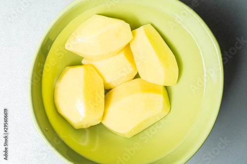 Peeled new potatoes in deep dish with water to remove nitrites.