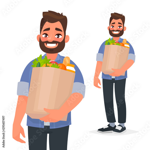 Happy man holding a grocery bag in his hands. Buyer at the supermarket