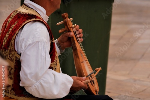 croatian street musican in tradional costume playing a typical Dalmatian lute called Lijerica in Dubrovnik photo