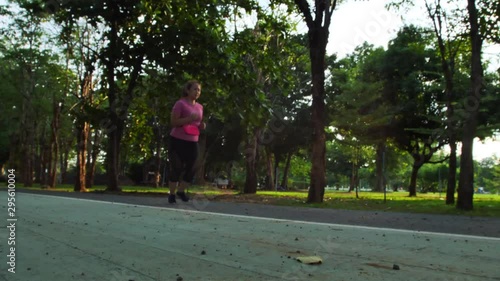 Wallpaper Mural Slow Motion Side view of women asian running, jogging in the park and evening sun. Good health and exercise Torontodigital.ca