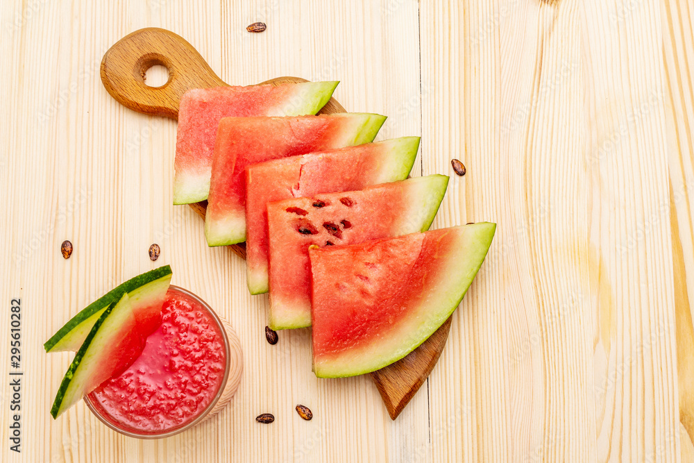 Fresh juice of watermelon, smoothie, cocktail. Sweet summer dessert, slices on wooden cutting board Fresh juice of watermelon, smoothie, cocktail. Sweet summer dessert, slices on wooden cutting board