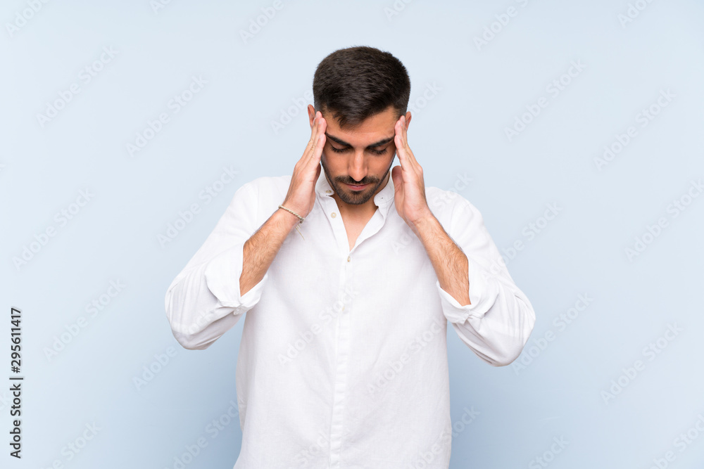 Handsome man with beard over isolated blue background with headache Handsome man with beard over isolated blue background with headache