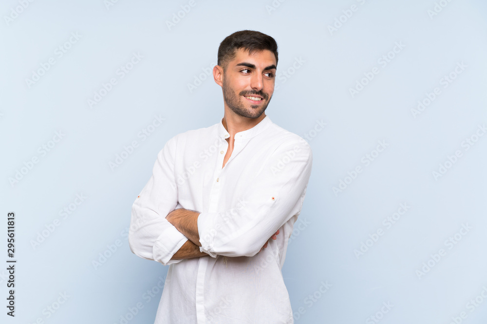 Handsome man with beard over isolated blue background with arms crossed and happy Handsome man with beard over isolated blue background with arms crossed and happy