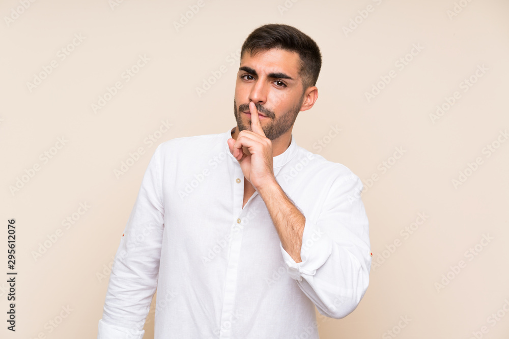 Handsome man with beard over isolated background doing silence gesture Handsome man with beard over isolated background doing silence gesture