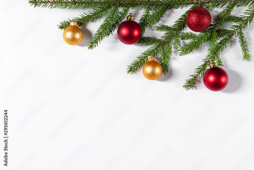Christmas border of fir branches, gold and red balls on a white background. Flat lay, top view, copy space. Christmas background Christmas border of fir branches, gold and red balls on a white background. Flat lay, top view, copy space. Christmas background