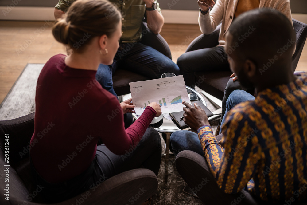 Fototapeta premium Close up of diverse South African Business meeting. Focus on hands and document being discussed