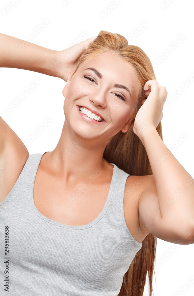 Young blonde girl in a gray shirt looks at the camera and smiles Young blonde girl in a gray shirt looks at the camera and smiles