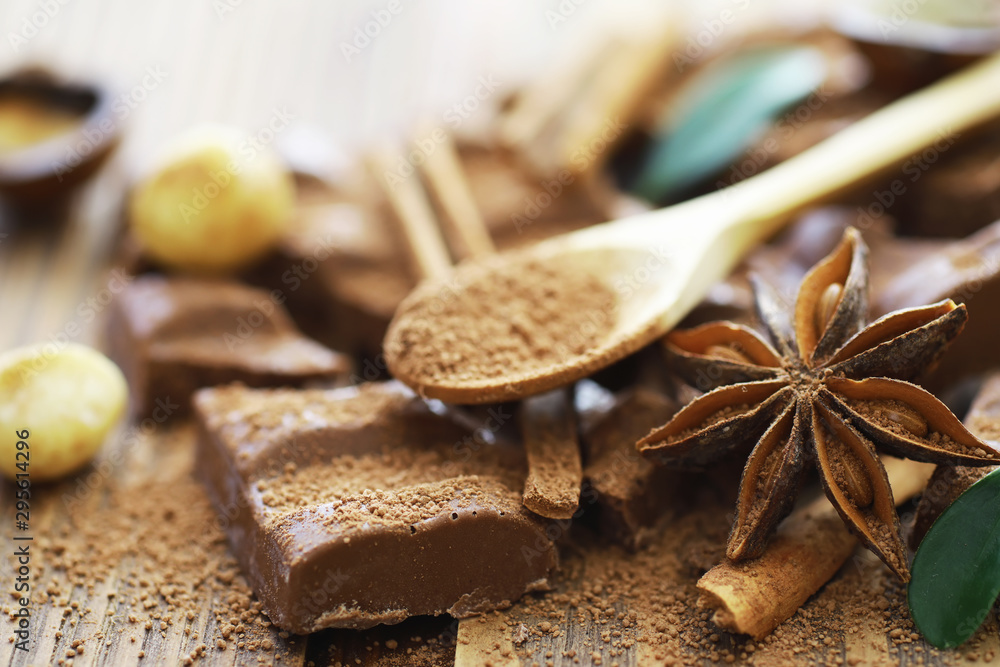 A bar of milk chocolate on the table. Chocolate with nuts and cinnamon. A bar of milk chocolate on the table. Chocolate with nuts and cinnamon.