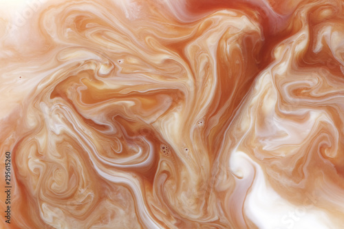 Фотография mixing coffee with milk, macro