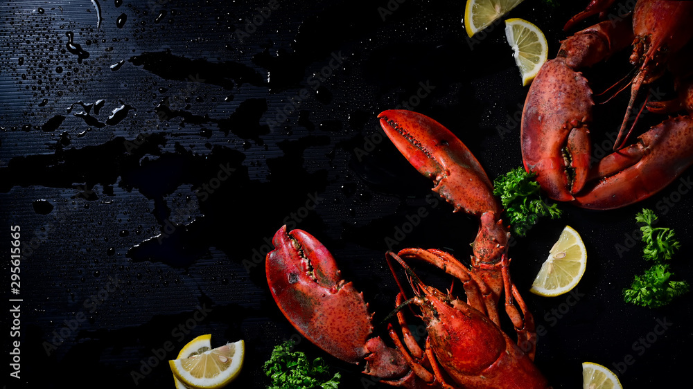 Above shot two lobster with lemon and parsley, Copy space dark background.