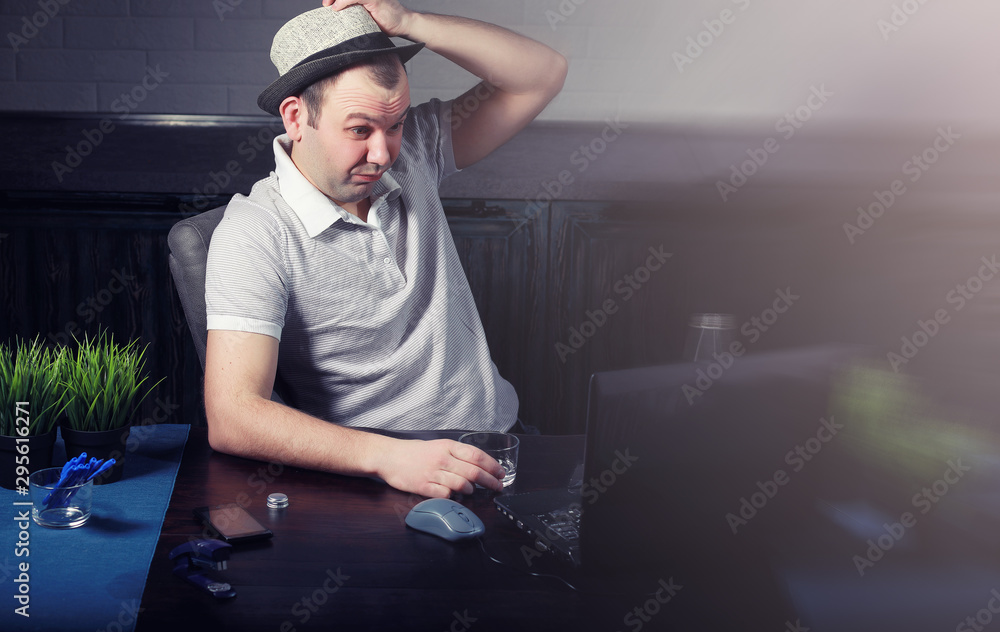 man at table and working on laptop