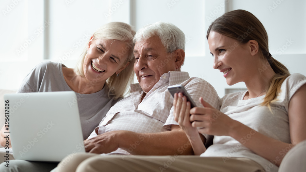 Three generations family with modern gadgets at home Three generations family with modern gadgets at home