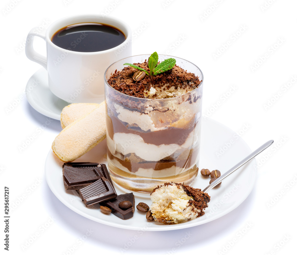 Classic tiramisu dessert in a glass, cup of coffee and pieces of chocolate on white background with clipping path Classic tiramisu dessert in a glass, cup of coffee and pieces of chocolate on white background with clipping path