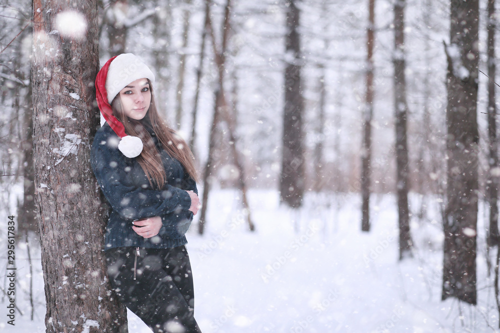 Girl in a winter park in snowfall Girl in a winter park in snowfall