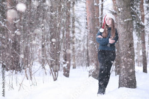 Girl in a winter park in snowfall