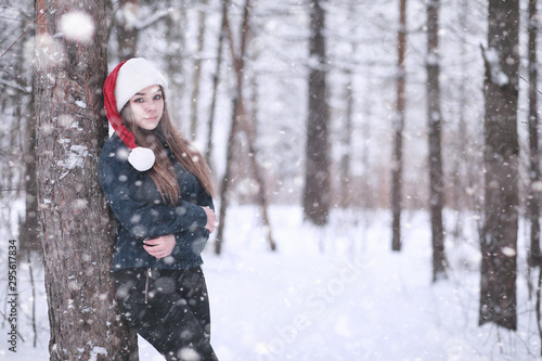 Girl in a winter park in snowfall © alexkich