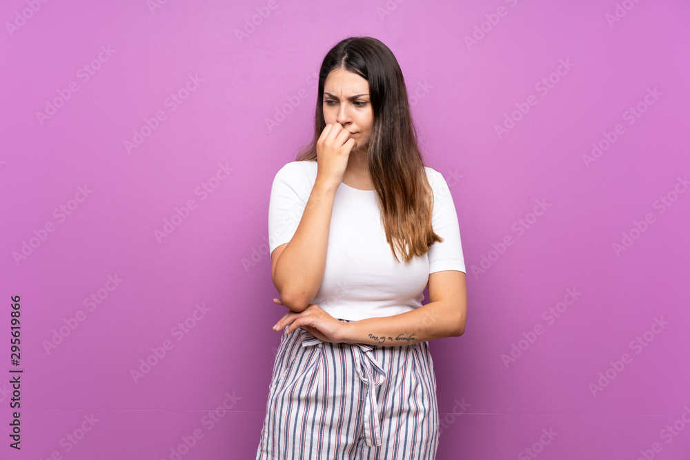 Young woman over isolated purple background having doubts Young woman over isolated purple background having doubts