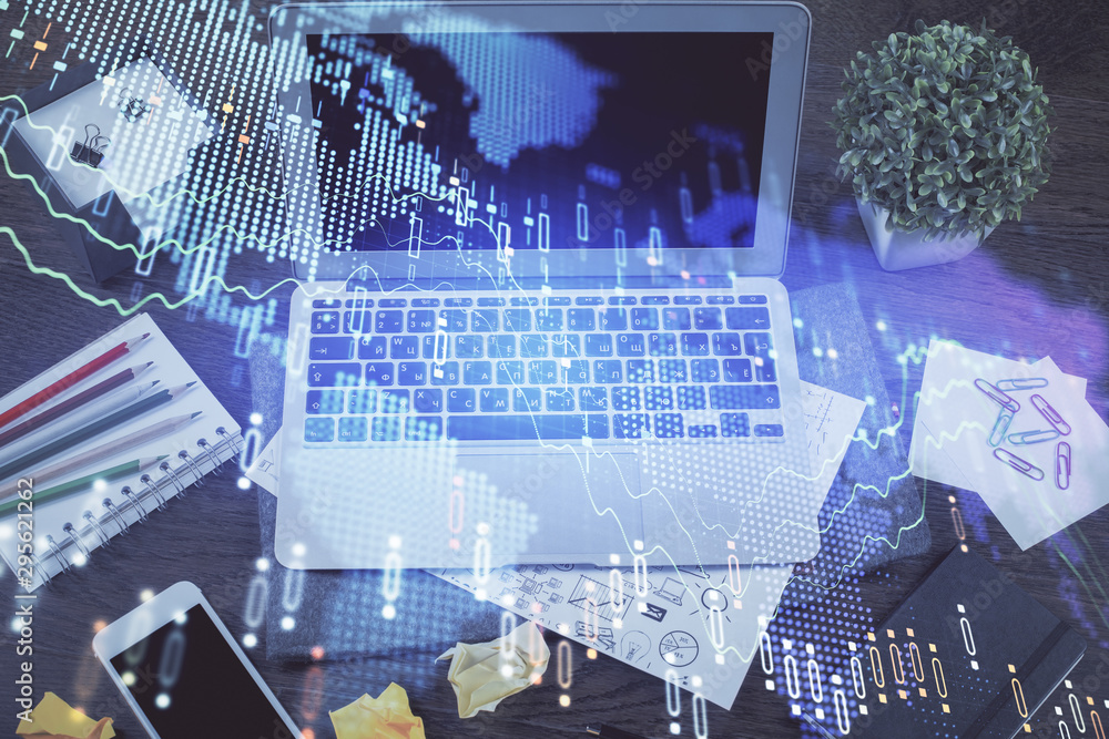 Financial graph colorful drawing and table with computer on background. Double exposure. Concept of international markets. Financial graph colorful drawing and table with computer on background. Double exposure. Concept of international markets.