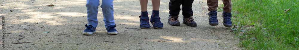 Feet of children who walk along the path
