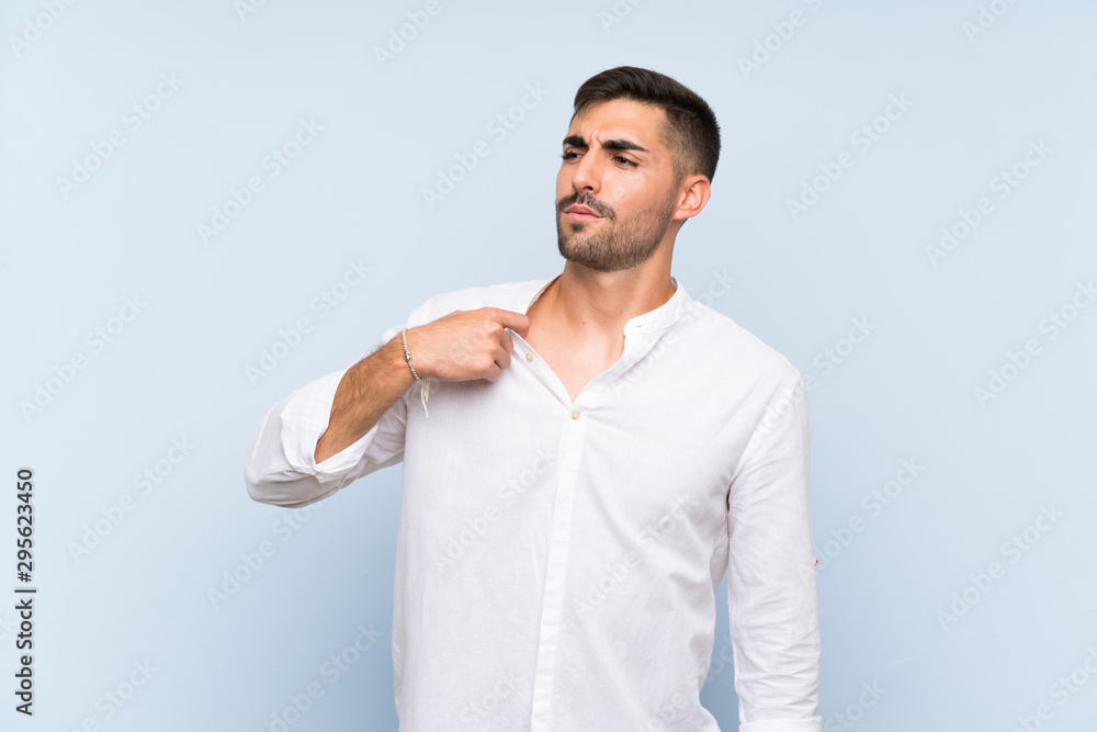 Handsome man with beard over isolated blue background with tired and sick expression Handsome man with beard over isolated blue background with tired and sick expression
